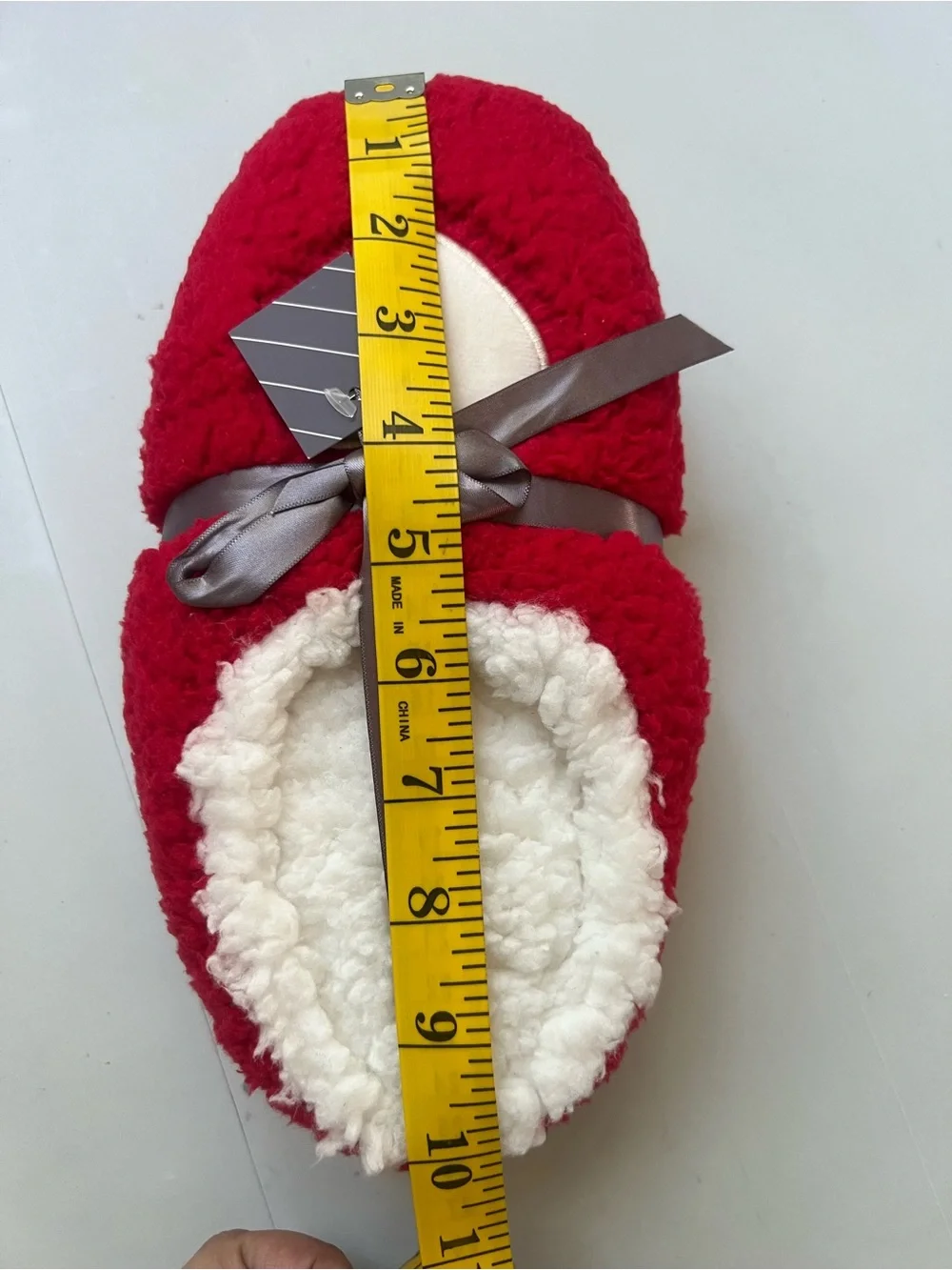 Red & white fuzzy slippers with white heart-shaped patch